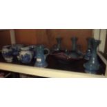 Shelf of various ceramic ware.