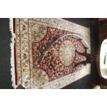 Silk and wool rug with floral design. {