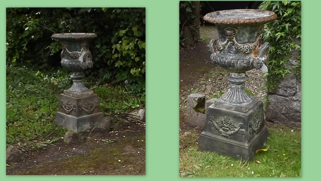 Pair of cast iron urns on stands.