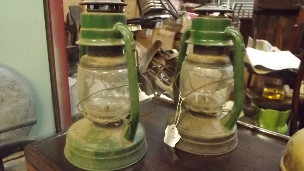 Two Hurricane lamps.