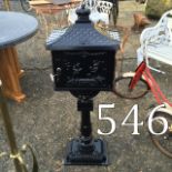 Metal post box on stand.