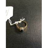 18ct. Gold ring set with a sapphire surr