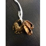 9ct. Gold charm in the form of a Lucky h