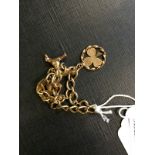 9ct. Gold charm bracelet with three char