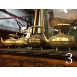 Four brass kettles.