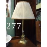 Brass bedside lamp with cloth shade.