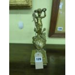 FRENCH GILT METAL MYSTERY CLOCK ADORNED WITH CHERUB AND TROPHIES WITH KEYS 24CM HIGH APPROX