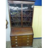 GEORGE III MAHOGANY BUREAU WITH STEPPED FITTED INTERIOR AND LATER ASTRAGAL GLAZED TOP