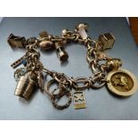 9CT GOLD LINK CHARM BRACELET AND 14 NOVELTY CHARMS 50.