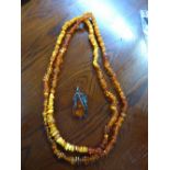 SIMULATED AMBER BEAD NECKLACE AND AN UNMARKED WHITE METAL ART NOUVEAU INSPIRED SIMULATED AMBER