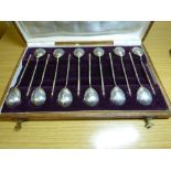 CASED SET OF TWELVE UNMARKED WHITE METAL TEA SPOONS WITH SPIRAL TWIST STEMS AND FLORAL ENGRAVED