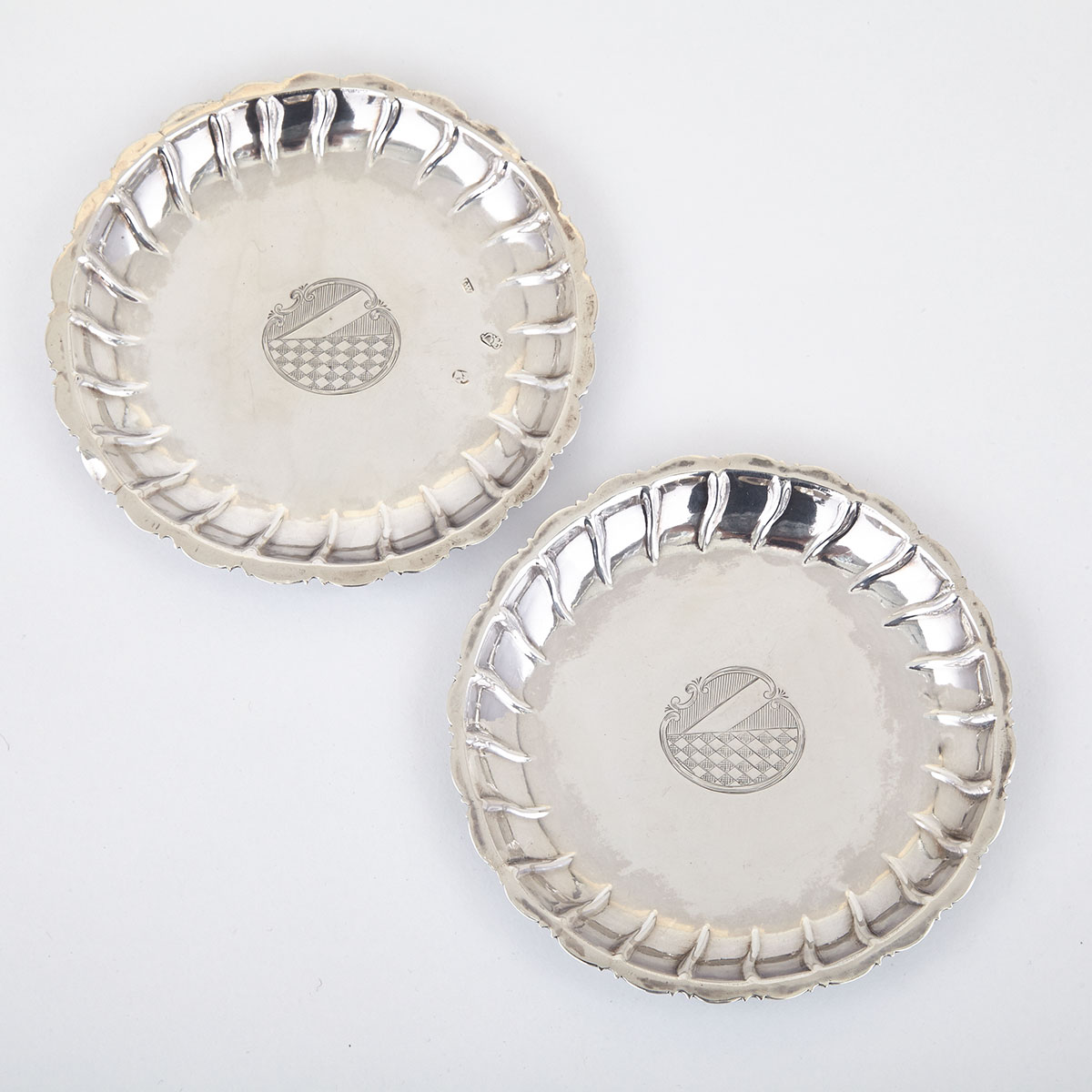 PAIR OF GEORGE I/II IRISH SILVER COUNTER TRAYS, JOHN WILME I, DUBLIN, 1724 AND C.1735 of circular