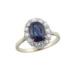 18K YELLOW GOLD AND PLATINUM RINGset with an oval cut sapphire (approx. 1.80ct.) encircled by 12