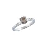 18K WHITE GOLD RINGset with a fancy brown old mine cut diamond (approx. 1.01ct.) flanked by 2