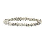 14K WHITE GOLD BRACELETformed in a floral motif and set with a brilliant cut and 114 single cut