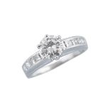 18K WHITE GOLD RINGset with a brilliant cut diamond (approx. 1.00ct.) flanked by 8 channel set