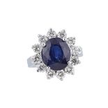 18K WHITE GOLD RINGset with an oval cut sapphire (approx. 5.00ct.) encircled by 12 brilliant cut