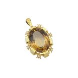 14K YELLOW GOLD PENDANTset with a large oval cut citrine (approx. 85.0ct.) in a mount decorated with