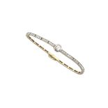14K YELLOW GOLD AND PLATINUM BRACELETbezel set with a European cut diamond (approx. 0.31ct.), with