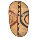 An African hide shield, of elongated oval form, hide tape bound frame, central wooden strut with