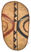 An African hide shield, of elongated oval form, hide tape bound frame, central wooden strut with