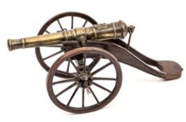 An early Victorian model cannon, brass barrel 7½” with stag’s head family crest at breech,