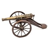 An early Victorian model cannon, brass barrel 7½” with stag’s head family crest at breech,