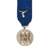 A Third Reich Luftwaffe long service medal 4th class,  with ribbon including eagle and swastika.