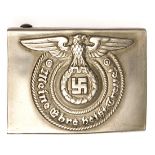 A Third Reich SS enlisted man’s belt buckle, of die stamped WM, stamped “O & C Ges Gesch” on