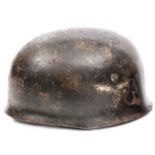 A Third Reich parachutist’s helmet,  with roughened dark green and tan camouflage, traces of