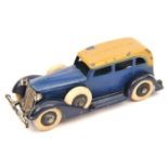 A Tootsietoy Graham saloon. In dark blue with beige roof and black wheels. White tyres to road