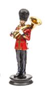 A Michael Sutty painted figure of a Sergeant bandsman of the Scots Guards,  in full dress playing