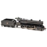 A Bassett-Lowke live steam O gauge 2-6-0 locomotive and tender. In BR red lined black livery, RN