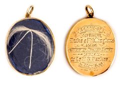 A gold coloured oval locket, engraved “A lock of Arthur, Duke of Wellington’s Hair, Given at