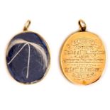 A gold coloured oval locket, engraved “A lock of Arthur, Duke of Wellington’s Hair, Given at