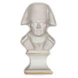 A French parian ware bust of Napoleon, wearing bicorne hat, on integral glazed gilt lined pedestal