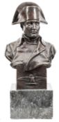 A large bronze head and shoulders bust of Napoleon, wearing bicorne hat and plain greatcoat,