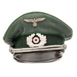 A Third Reich Army NCO’s peaked cap, with dark green band, apple green piping, silver cords and