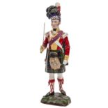 A continental painted porcelain figure “Seaforth Highlander, 1815”, officer in full dress with