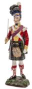A continental painted porcelain figure “Seaforth Highlander, 1815”, officer in full dress with