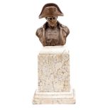 A bronzed head and shoulders bust of Napoleon, wearing bicorne hat, height 4½”, on a heavy marbled