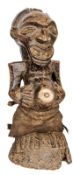 An early 20th century Songey carved wood fetish figure from the Congo, in the form of an old man
