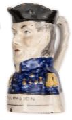 A 19th century Toby jug in the form of the head and shoulders, Duke of Wellington, in blue headdress