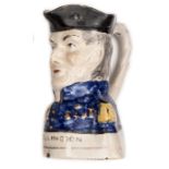 A 19th century Toby jug in the form of the head and shoulders, Duke of Wellington, in blue headdress