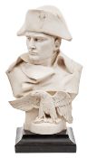 A white marble head and shoulders bust of Napoloen, wearing bicorne hat, with high collar to