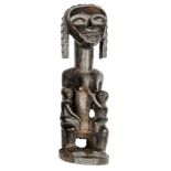 A mid 20th century Attie carved dark wood maternity figure from the Ivory Coast, in the form of a