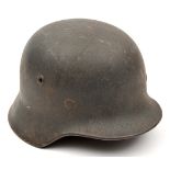 A Third Reich M40 steel helmet, with dark grey finish and single Luftwaffe eagle decal, stamped “