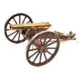 A modern model of an early 19th century field gun, brass barrel 9”, on its 2 wheeled carriage with