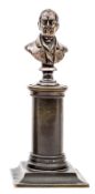 A miniature brass bust of Wellington,on a bronzed column and pedestal base, 5½” overall. GC