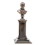 A miniature brass bust of Wellington,on a bronzed column and pedestal base, 5½” overall. GC